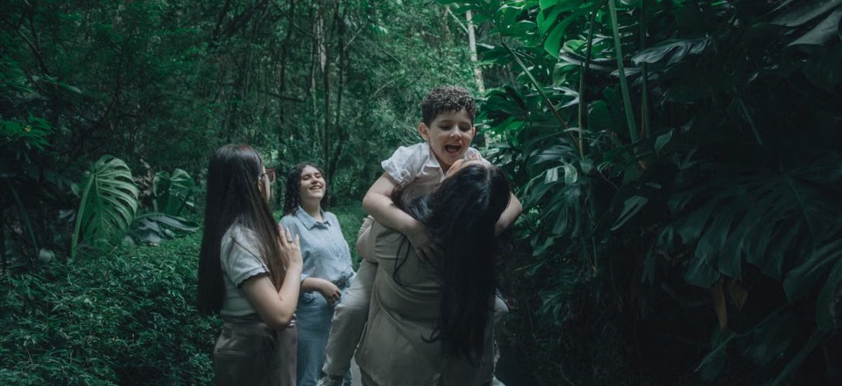 A joyful family bonding in a lush green forest, embracing nature.