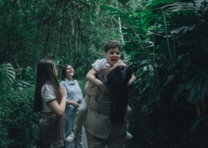 A joyful family bonding in a lush green forest, embracing nature.